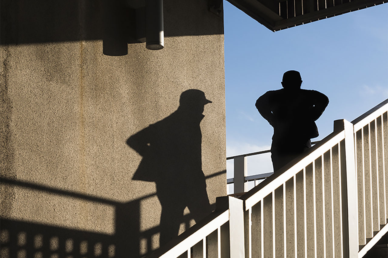 Man's shadow and handrail